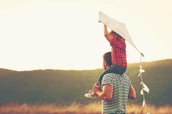 Father and Son Flying a Kite Together
